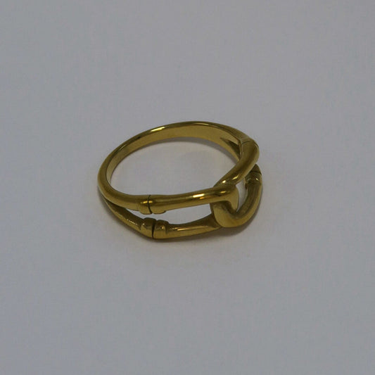 Gold ring on a light gray background