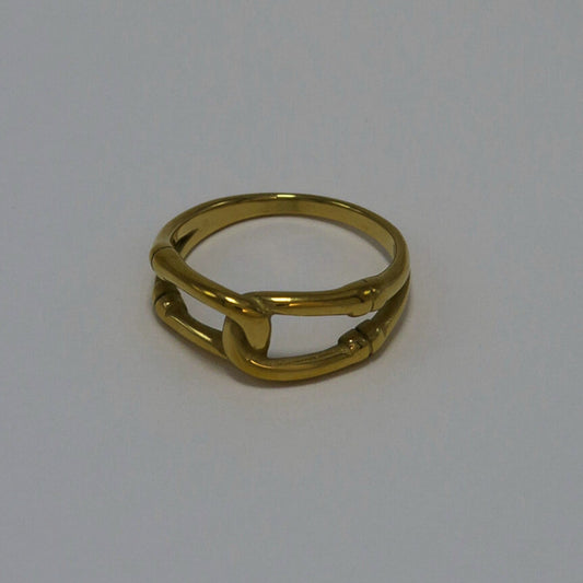Gold ring on a light gray background